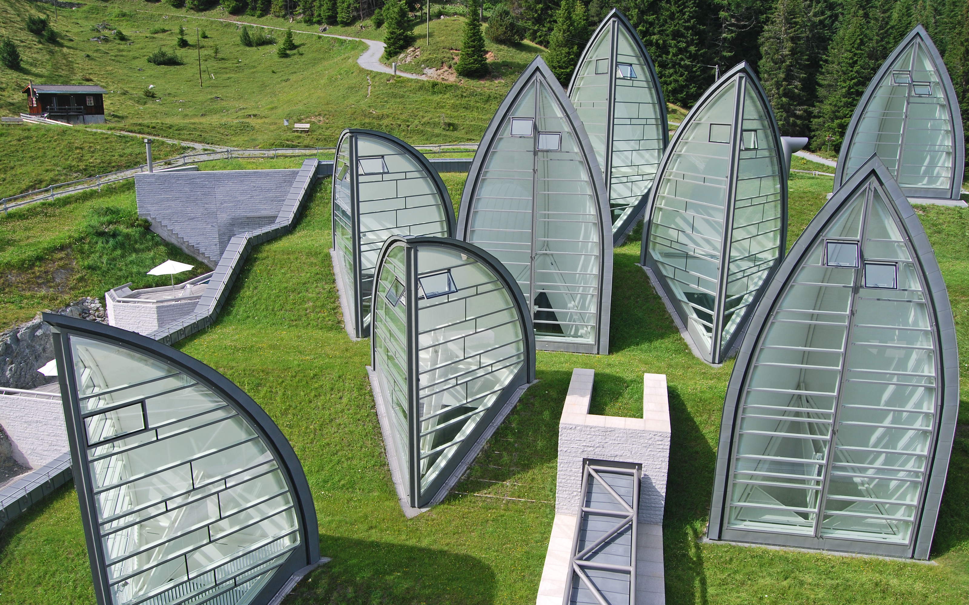 Pitched green roof with lawn and light sails